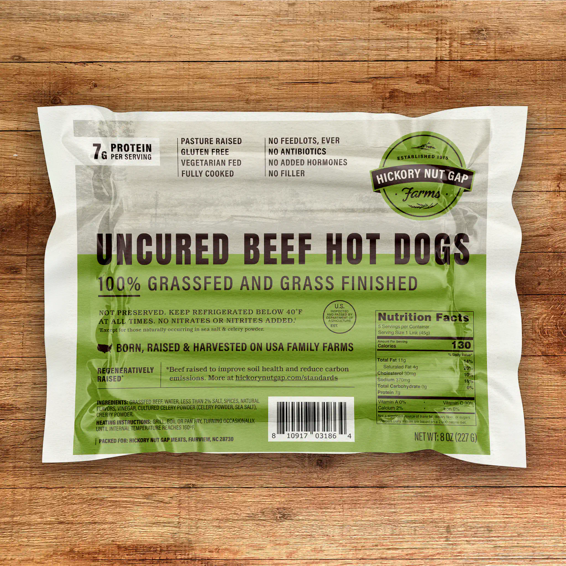 Package of uncured beef hot dogs with Hickory Nut Gap Farms branding on a wooden surface